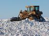 Dozer stacking snow pile